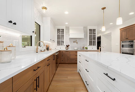 Kitchen with a white quartz island and wood lower cabinets, Narrative Interiors interior design serving Loveland, CO