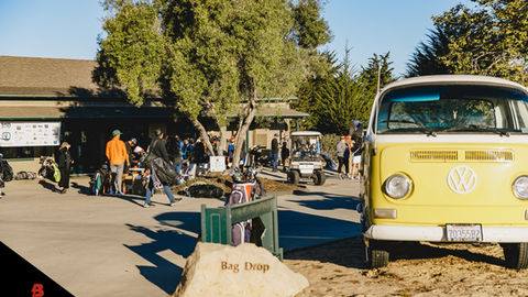 a yellow van is parked next to a rock that says bag drop
