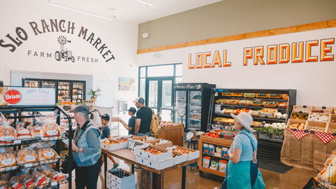 people are shopping at a local produce market