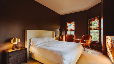 a bedroom with a king size bed and two chairs