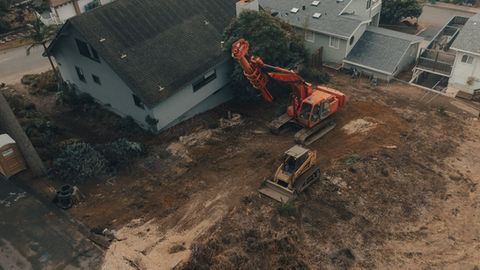 an aerial view of a construction site with a bulldozer and an excavator