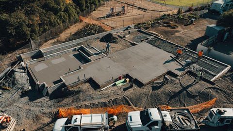 an aerial view of a construction site with a playground in the background