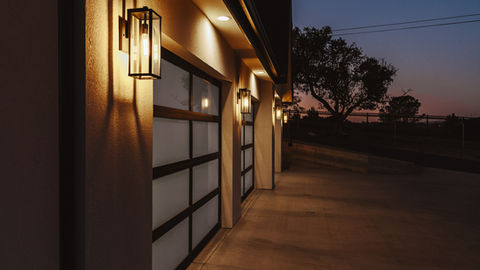 a row of garage doors are lit up at night