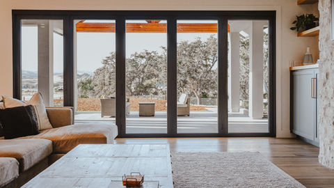 a living room with sliding glass doors leading to a patio