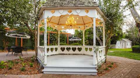 a gazebo with heart shaped cutouts and a chandelier