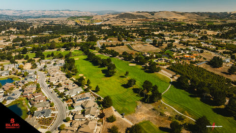an aerial view of a golf course in a residential area