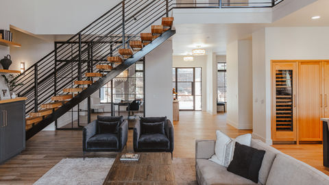 a living room with a staircase leading up to the second floor