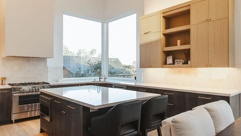 a kitchen with a large island and two chairs