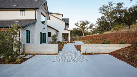 a white house with a brick walkway leading to it