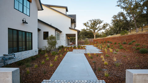 a white house with a brick walkway leading to it