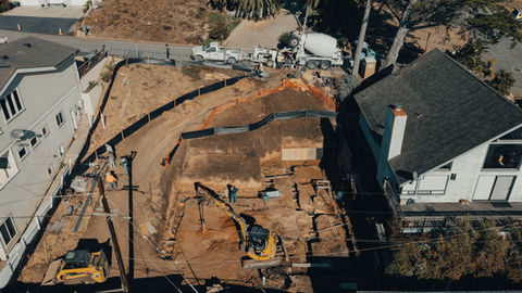 an aerial view of a construction site with a yellow excavator
