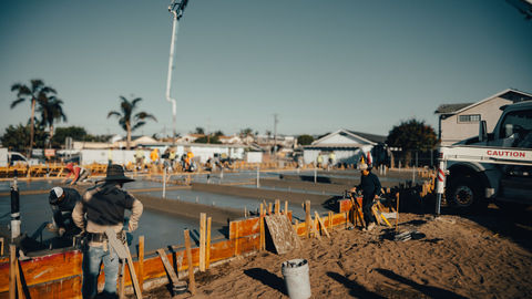 a construction site with a bucket in the foreground