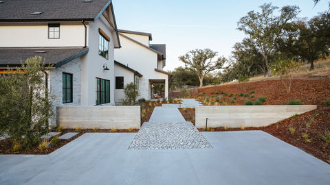 a white house with a brick walkway leading to it