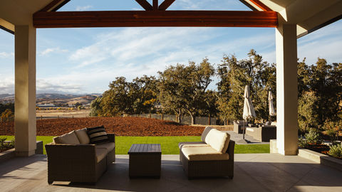 a patio with a view of trees and mountains