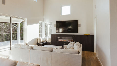 a living room with a fireplace and a flat screen tv