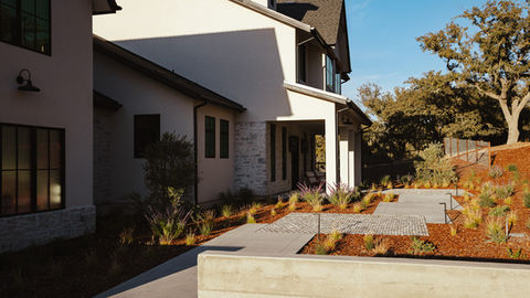 a house with a concrete walkway leading to it
