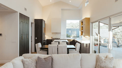 a living room with a couch and a table and chairs