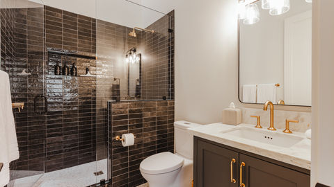 a bathroom with a toilet a sink and a shower