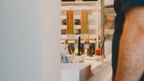 a person at an ice cream counter paying