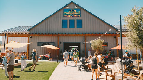a large building with a sign that says slo life