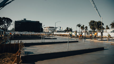 a group of construction workers are working on a concrete floor