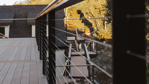 a deck with a railing and stairs leading up to it