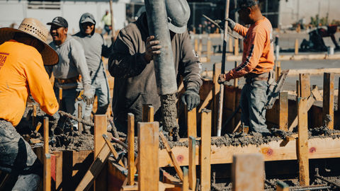construction worker operating the concrete boom while pouring concrete