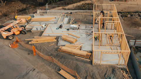 an aerial view of a house being built with a lot of wood on the ground