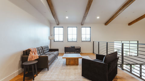 a living room with a couch and two chairs