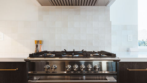 a stainless steel stove top oven with a hood above it