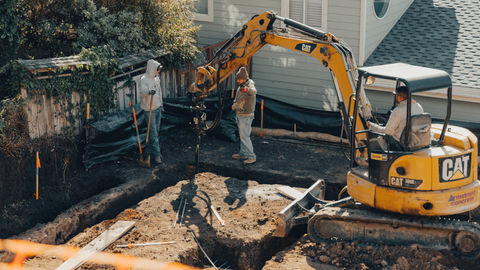 a cat excavator is being used to dig a hole