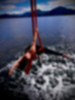 Franni on an aerial silk, suspended over open ocean