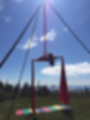 Franni hanging from a silk before open sky