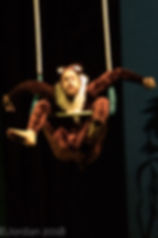 Charles as a monkey in "Jungle Book," doing a knee hang