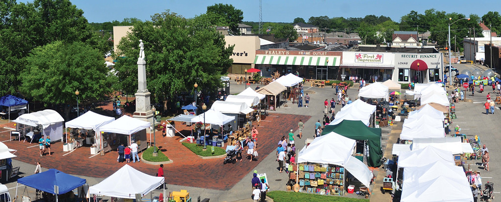 Downtown Troy, AL on beautiful TroyFest say. Many peopl shopping multiple vendors.