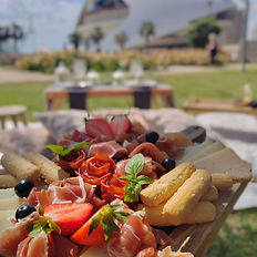 dried meat and cheese board and picnic in a park