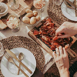 cured meat platter and two hands picking from it