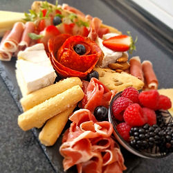 colourful cheese board with meats and fruits