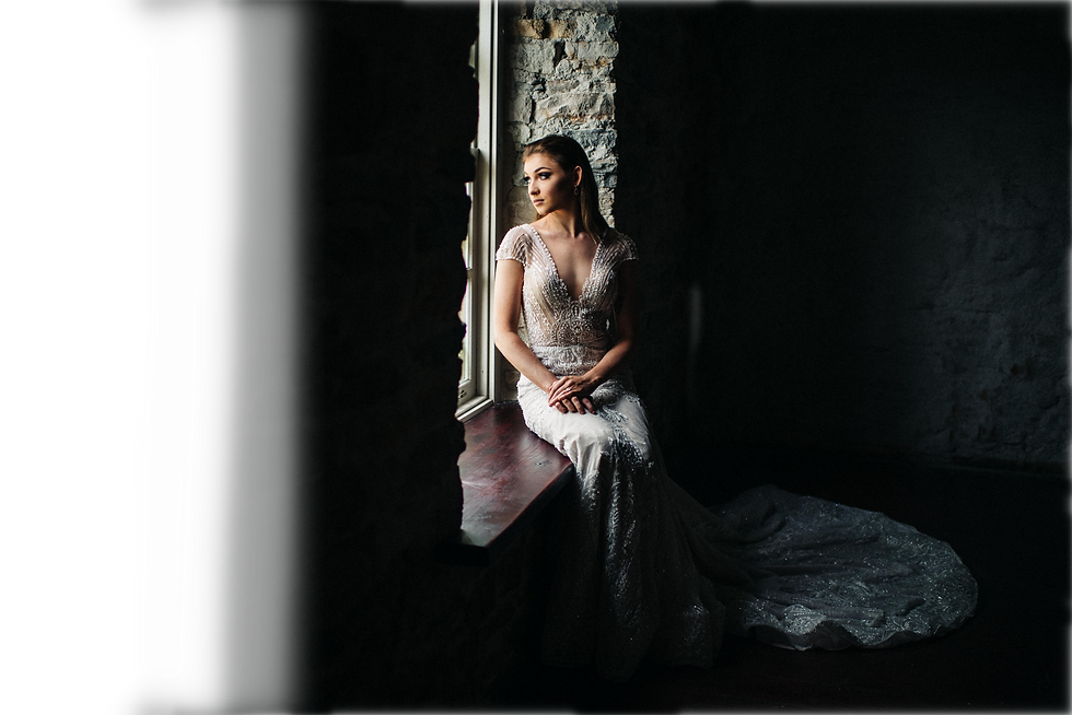 Bride sitting on window sill at Code's Mill
