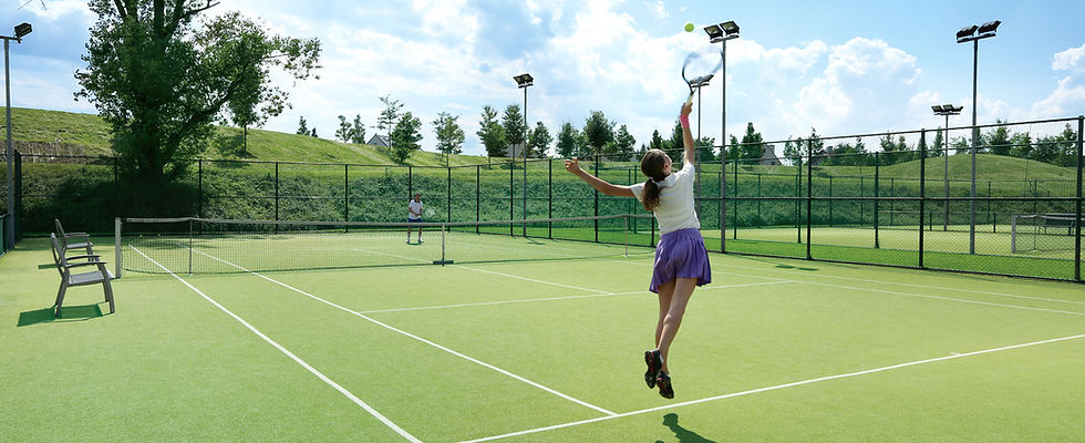 Woman serving tennis ball