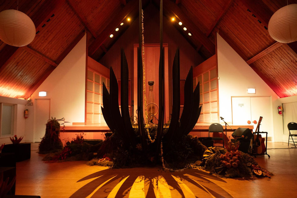 Dramatic stage with dark, pointed sculpture and lighting.