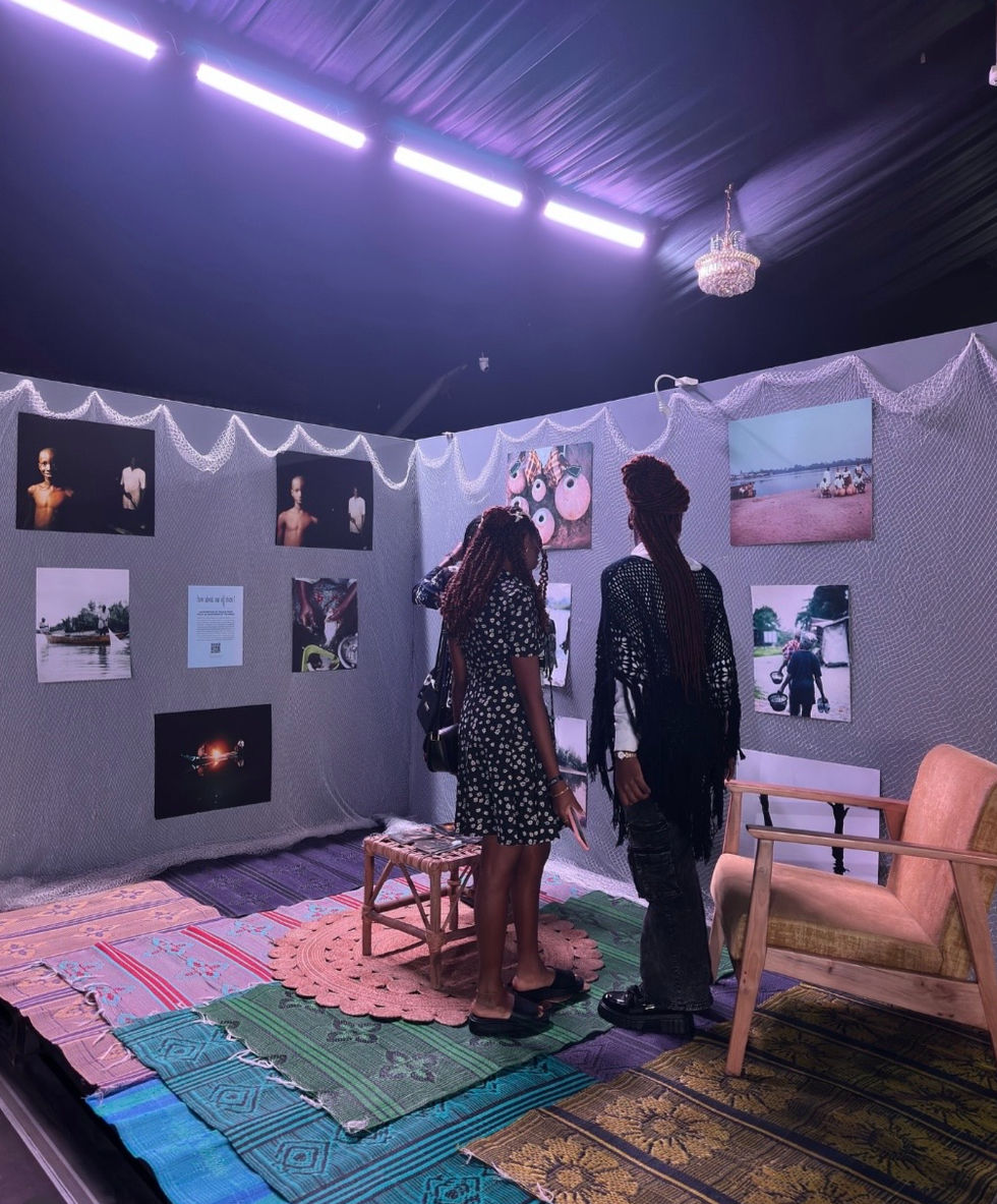 People viewing art in a dimly lit gallery.