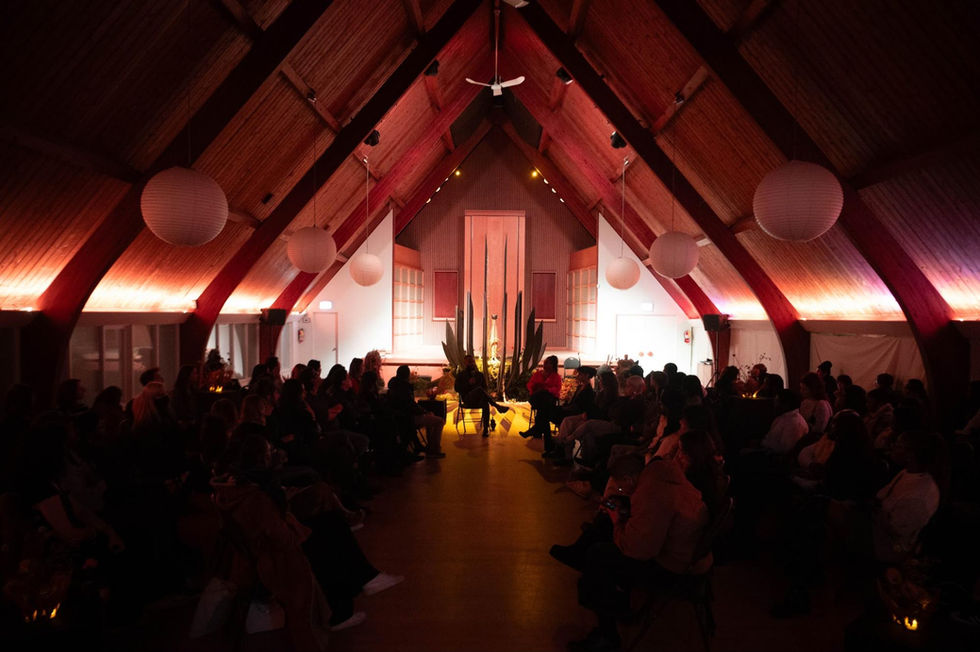 Dimly lit event in a vaulted ceiling venue.