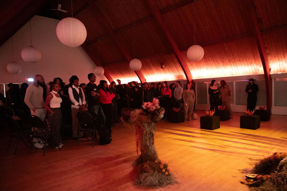 People gathered in warmly lit room with decorations.