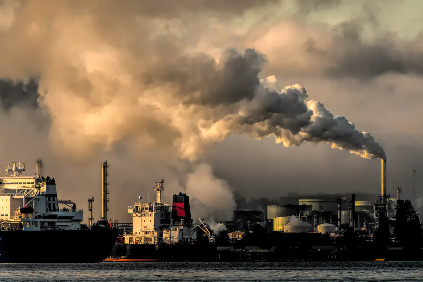 A picture of freighters in a port, high degree of polution