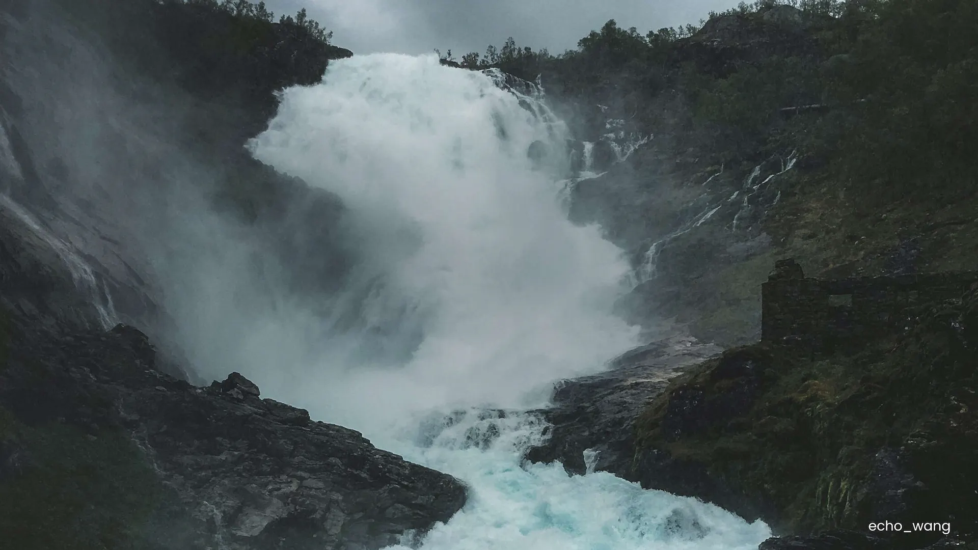 Lead image of a waterfall in dark, foggy weather