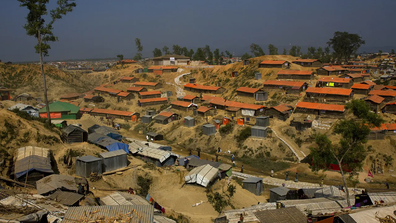 An aerial shot of a several houses on the outskirts of Bangladesh.