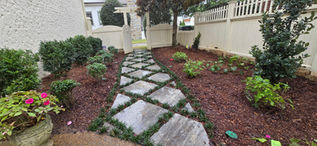 Alternate angle of planting, mulch, walkway, and mondo grass installation between pavers