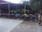 Children gathered under a pavilion for Christian child sponsorship Program.