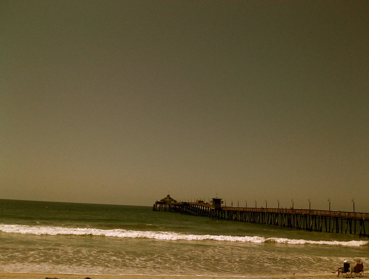 couple on shore, beside pier